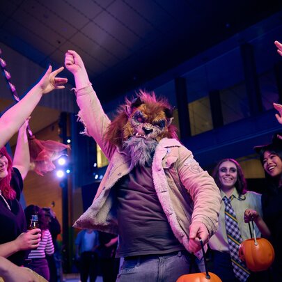 People in Halloween costumes dancing.