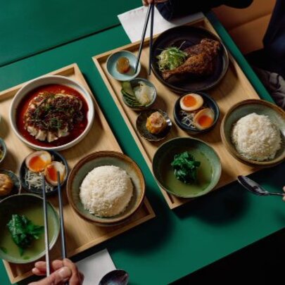 Lunch tray-style Asian meal with multiple bowls of food on a tray.