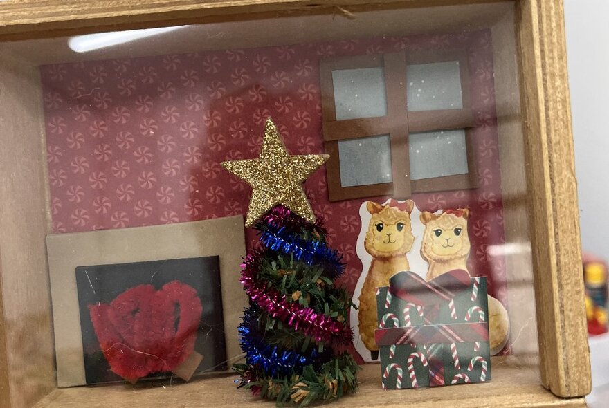 Hand crafted diorama with a Christmas tree and two small critters. 