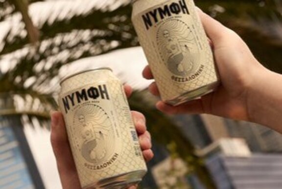 Hands holding cans of Greek beer.