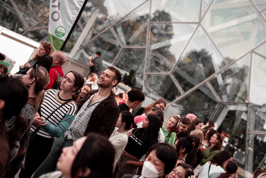 Crowds of people standing in the Edge at Fed Square.