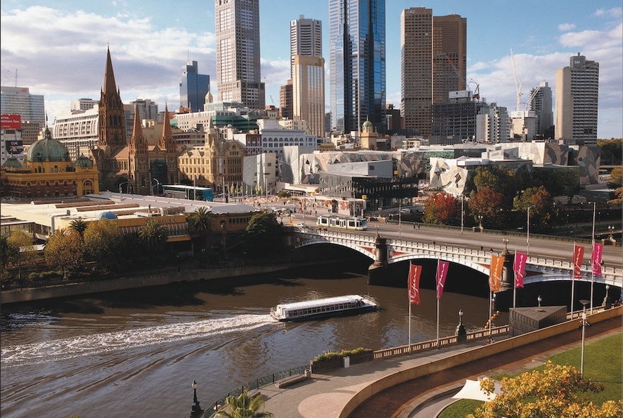 Cruise boat passing under Princes Bridge on the Yarra River.