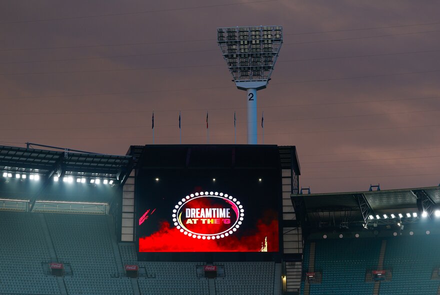 The large screen at the MCG at night with the words 'Dreamtime at the G' just visible.