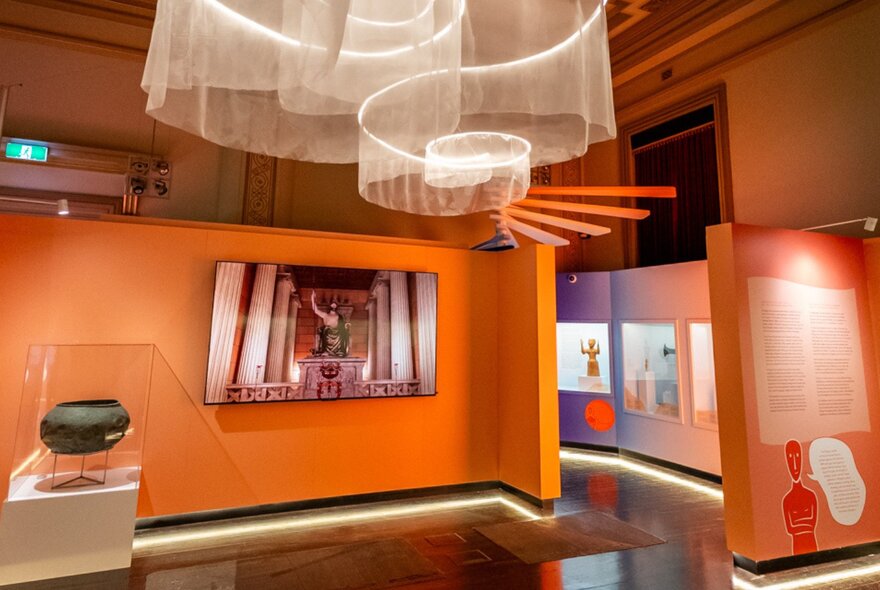 Installation view of an exhibition at Hellenic Museum in Melbourne, showing artworks on the walls.