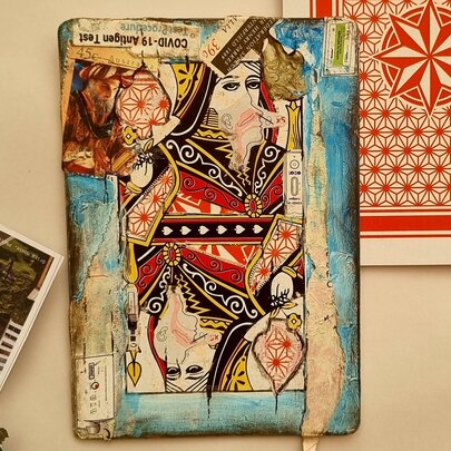 A mixed-media artwork on an oversized playing card.