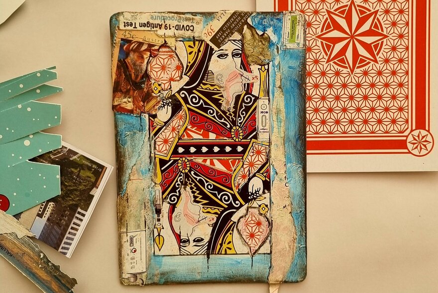 A mixed-media artwork on an oversized playing card.