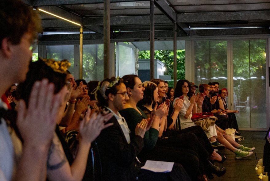 People listening to a talk inside the Hellenic Museum.