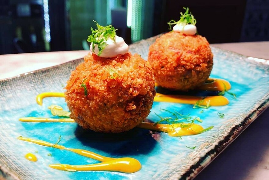 Two fried balls of Spanish tapas.