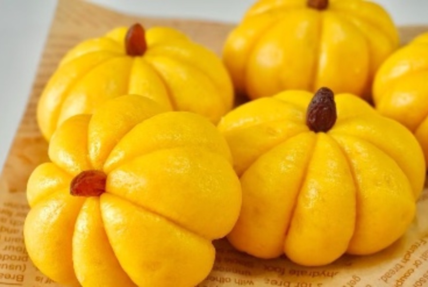 Yellow dumplings on a printed platter.