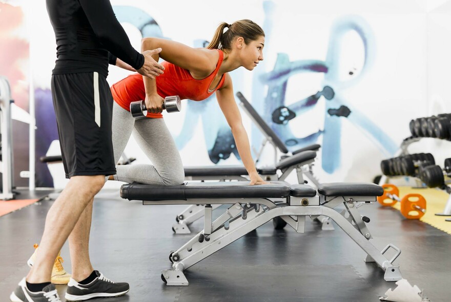 People exercising and lifting weights in Melbourne City Baths fitness centre.