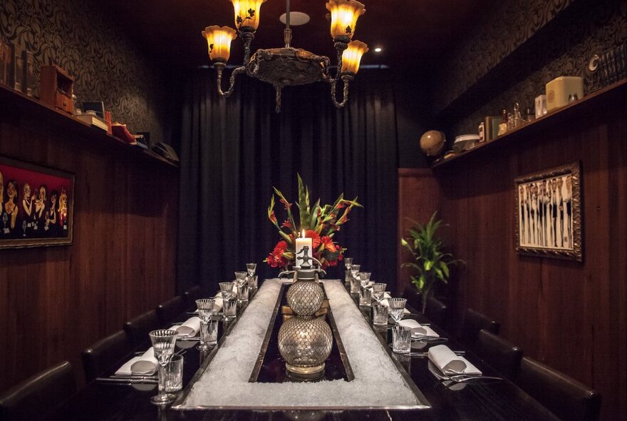 A private dining room at Eau-de-Vie with wood panelled walls and dim lighting.