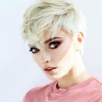 Woman displaying stylish haircut.