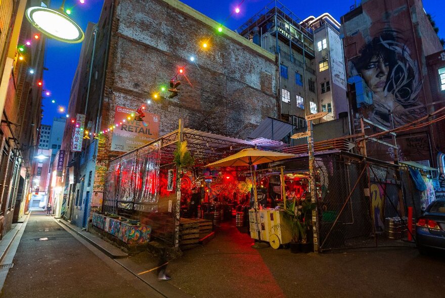 Hidden laneway bar with fairy lights hanging above.