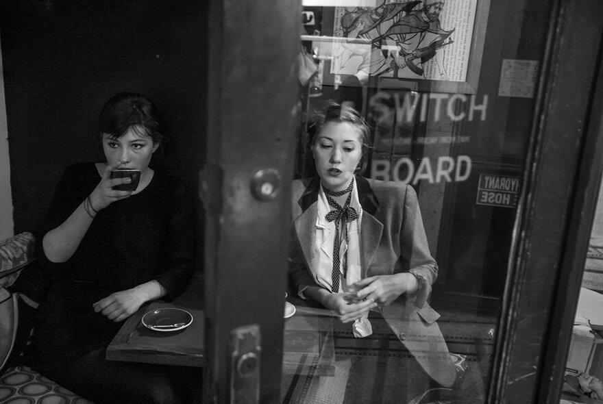 Customers drinking coffee outside Switchboard Cafe in Melbourne.