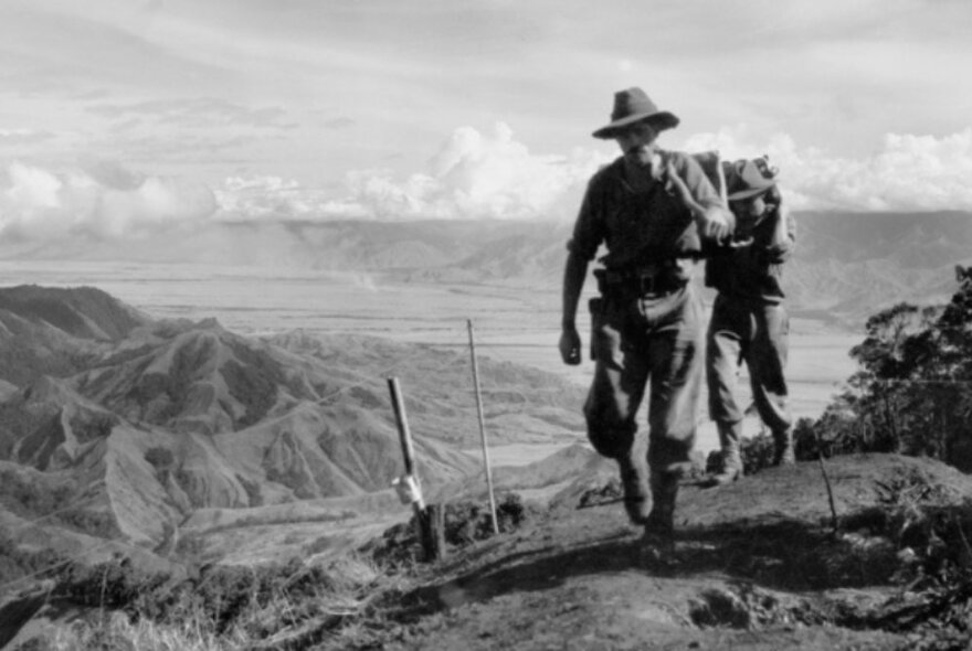 Black and white photograph person on a mountain ridge in the highlands of Papua New Guinea. 