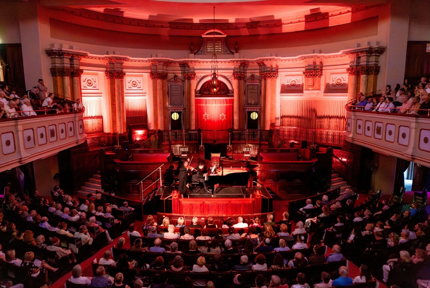 Toorak synagogue interior with rows of seating and classical architecture.