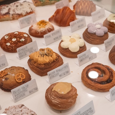 Japandi pastries with different toppings and shapes lined up in a row with description notes.