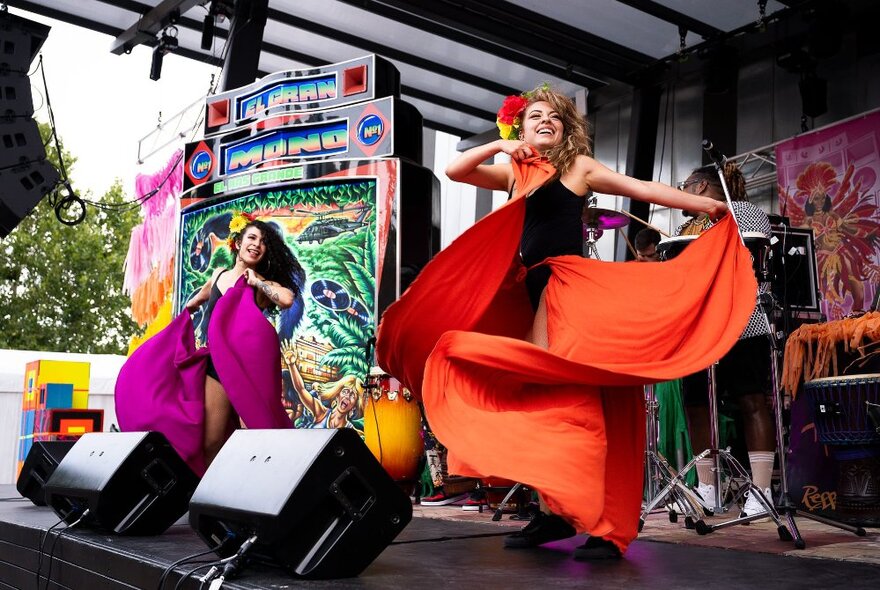 Dancers on stage swirling their colourful skirts at a festival in Fed Square.