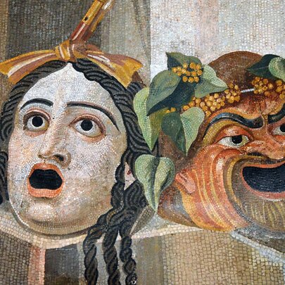 Mosaic depicting theatrical masks of tragedy and comedy.