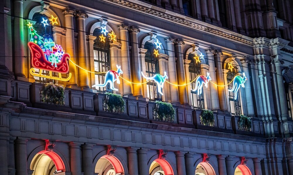 A neon light display of Santa's sleigh being pulled by kangaroos.