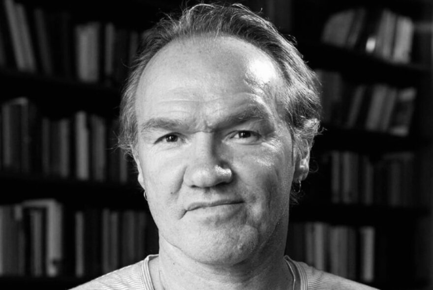 A black and white head shot of Tony Birch with a slight sideways smile. 