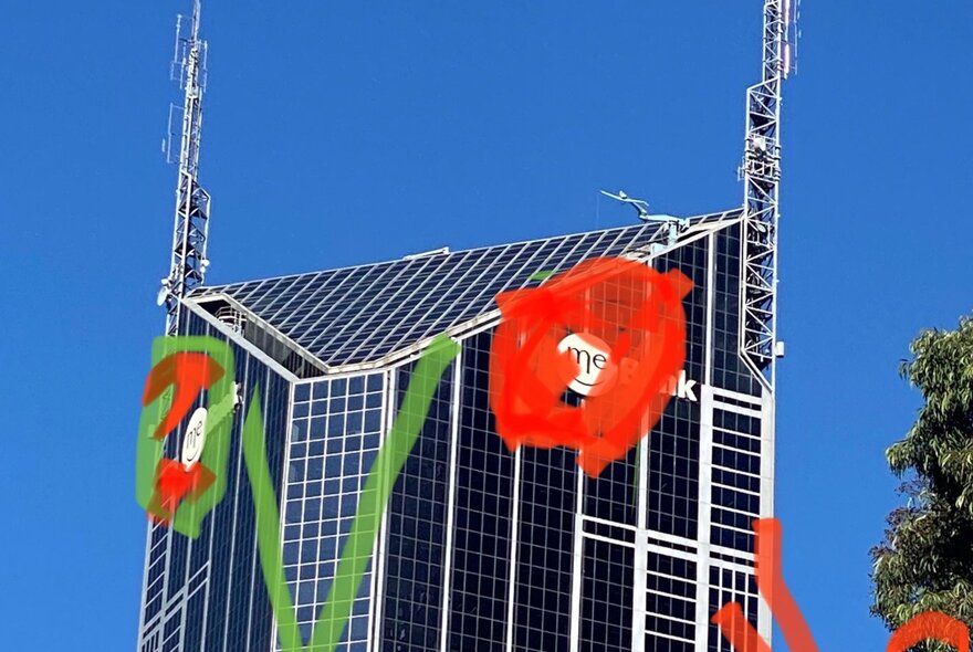 A city building with childish drawings of red flowers over the top. 