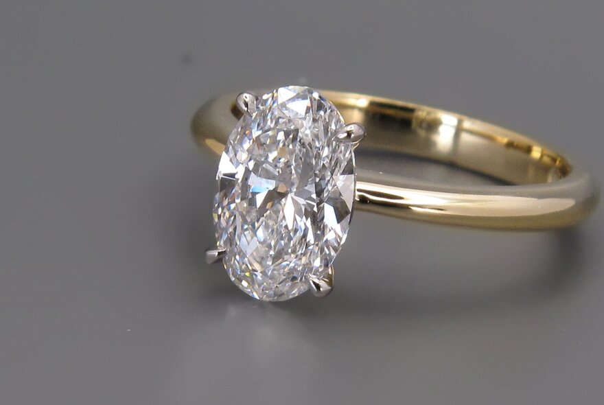 A gold ring with a large central diamond.
