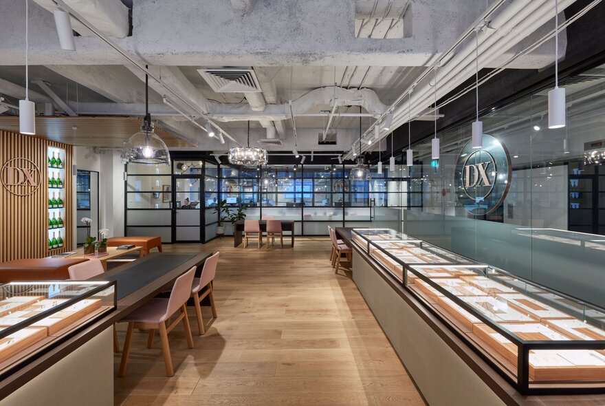 The interior of a jewellery store with sleek cabinets and glass light fittings.