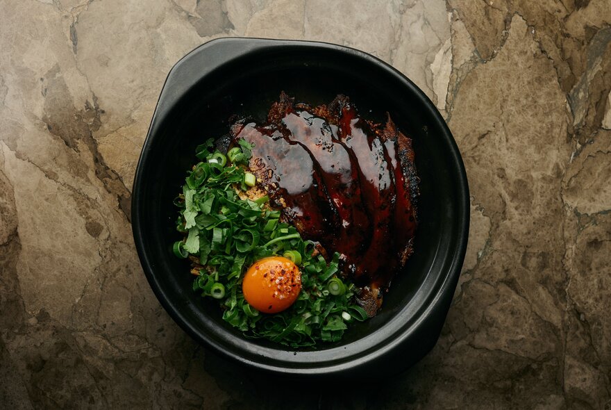 Claypot broken rice with pork cheek and egg yolk.