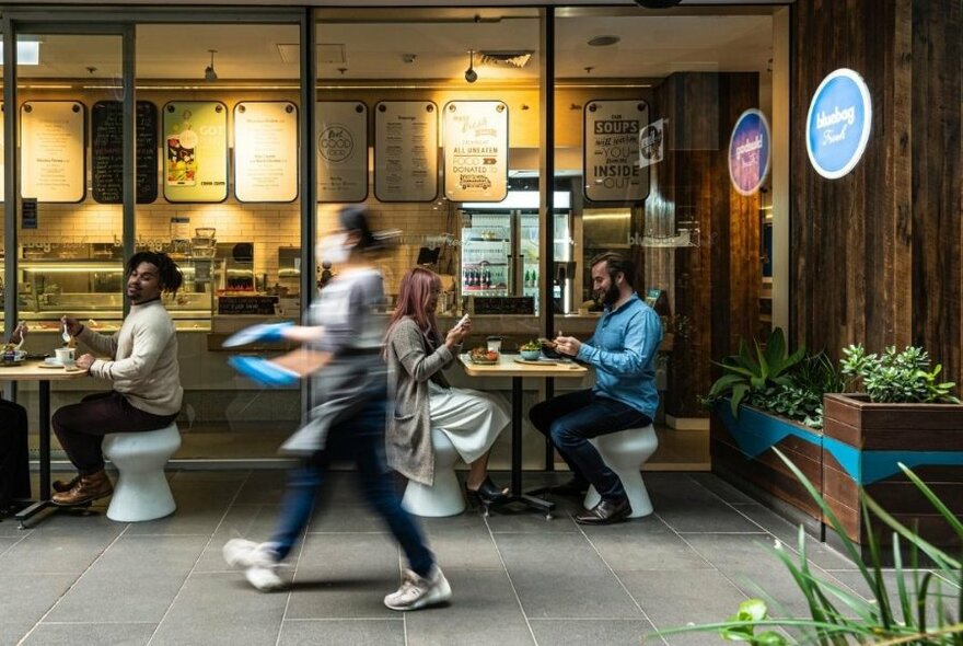 People seated outside a cafe.