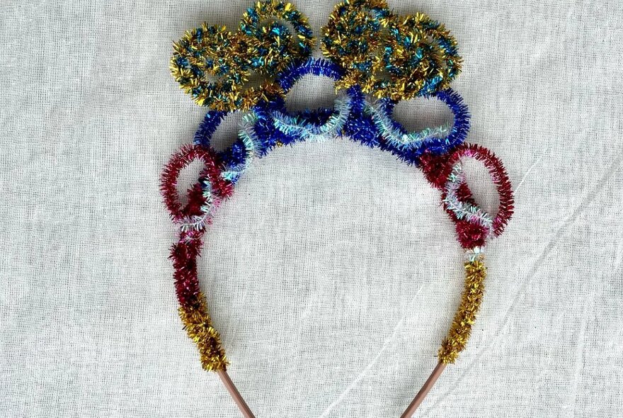 A headband with coloured pipe cleaners to make a cute crown.