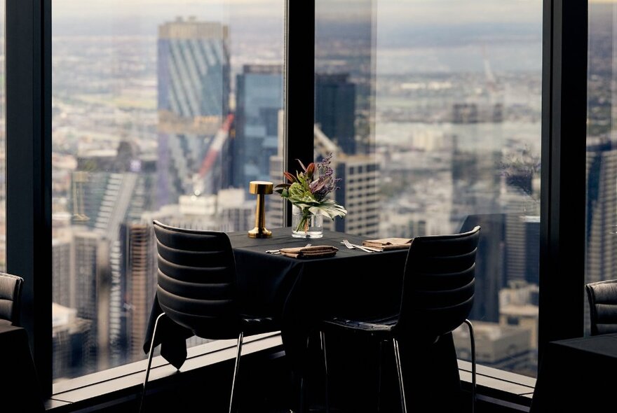 A table for two set up for dinner at Eureka Tower with views over the city of Melbourne.