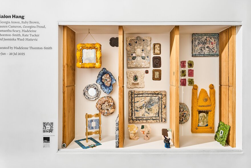 Installation view of an exhibition of framed artworks on display on the white gallery walls of Craft.