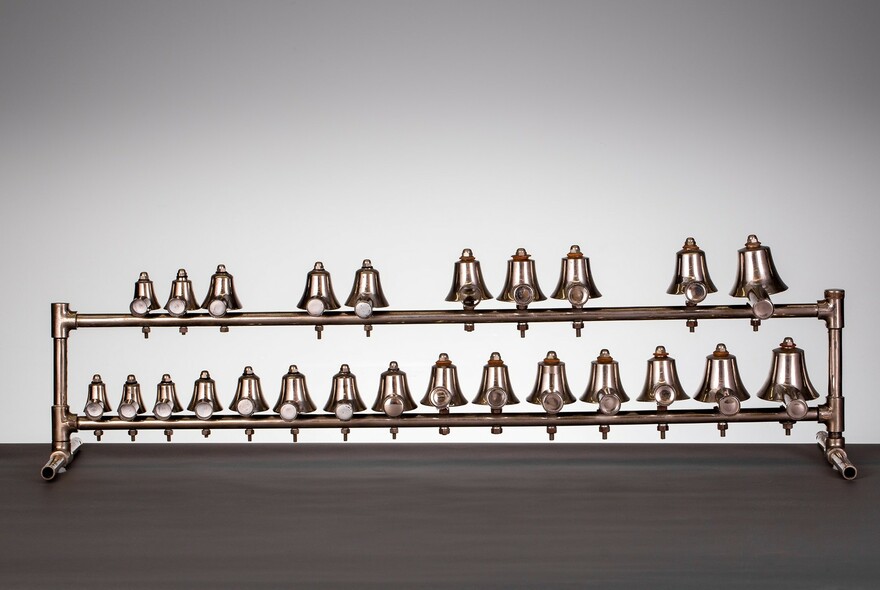 Series of bells, mounted on poles, at Grainger Museum.