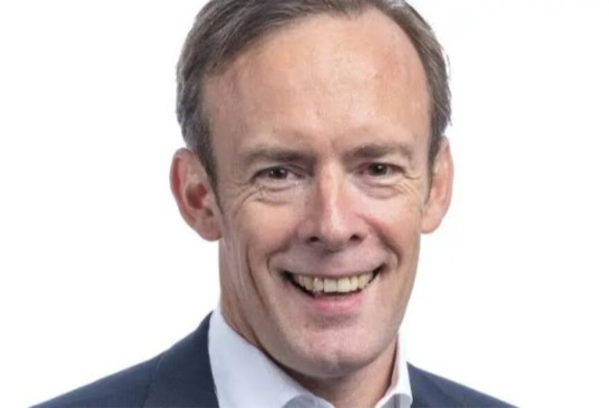 Technology CEO Aidan Tudehope, smiling wearing open-necked shirt and jacket.