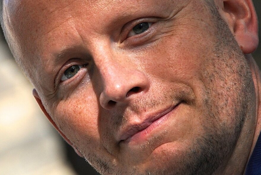 A close up facial shot of author Patrick Ness. 