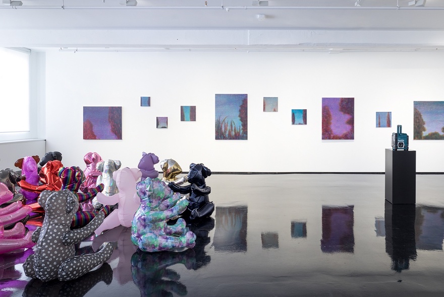 Exhibition installation view at Tolarno Gallery, with sculptural works on the floor and paintings hanging on the white gallery walls.