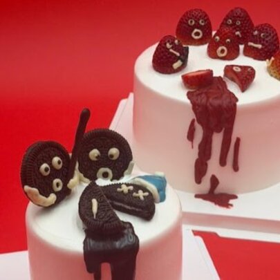 Two cakes with toppings depicting murder scenes.