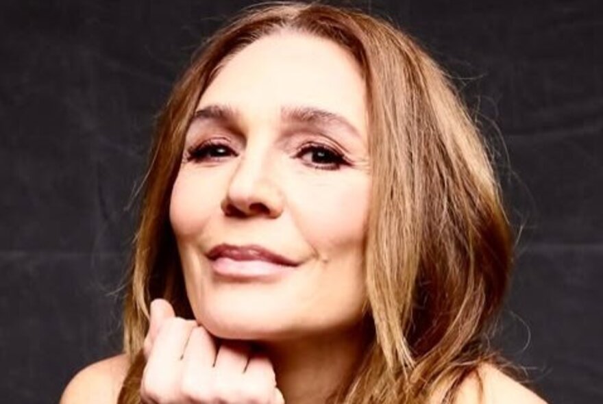 Tottie Goldsmith, resting her chin on her hand.