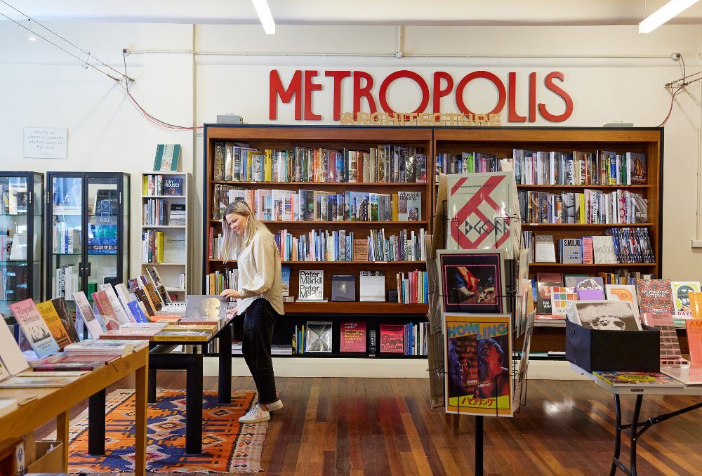 A woman is in a bookshop browsing books