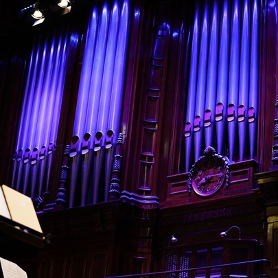 A Grand Organ, illuminated in blue / purple.