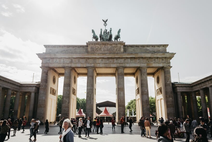 People milling around the Brandenburg Gate in Berlin.