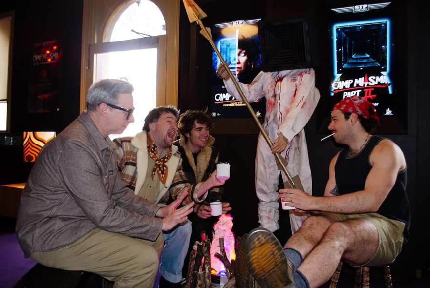 People seated wearing movie-themed outfits in a bar setting.