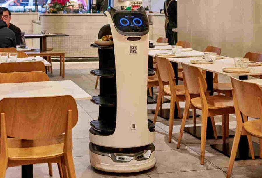 A robotic machine serves food at a restaurant.