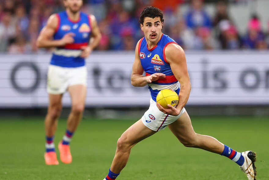 Western Bulldogs player Joel Freijah moves the ball during a football match. 