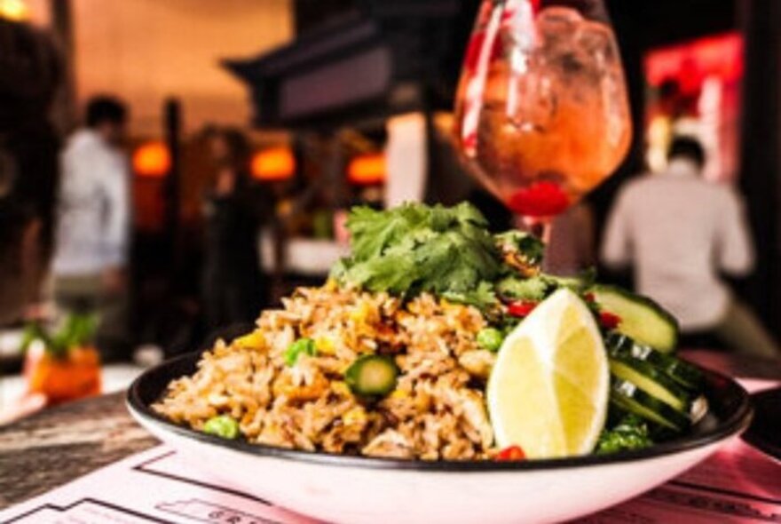 Bowl of Thai food and a drink.