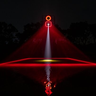 A lighting display that shows a red design with a square and a light above and below. 