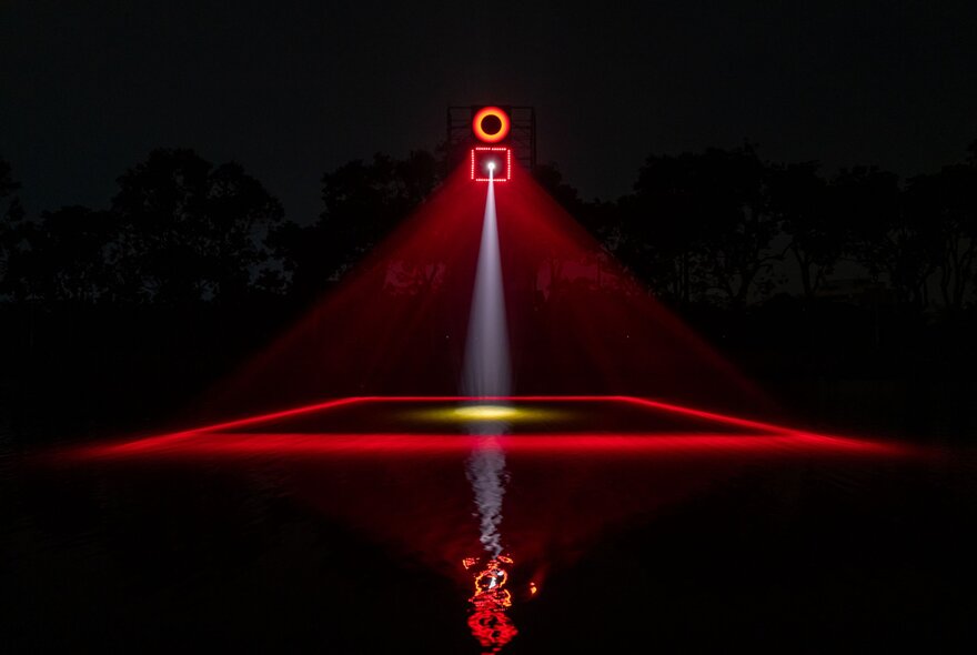 A lighting display that shows a red design with a square and a light above and below. 