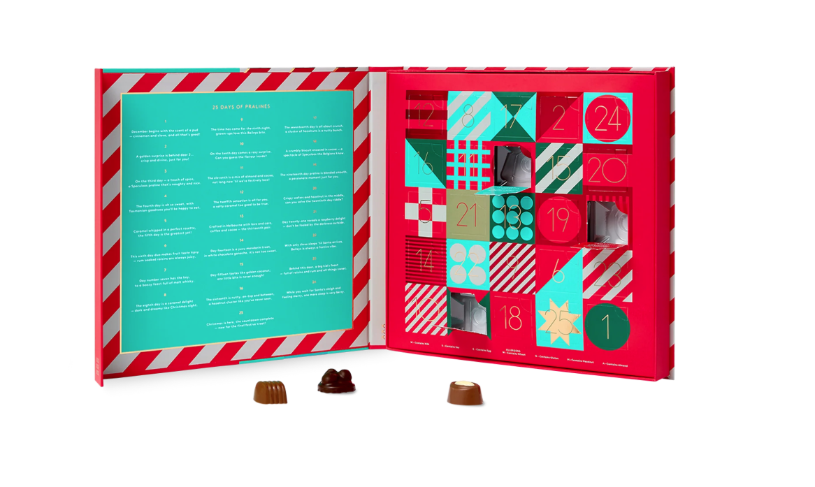 A colourful Christmas advent calendar with chocolates taken out of the doors.