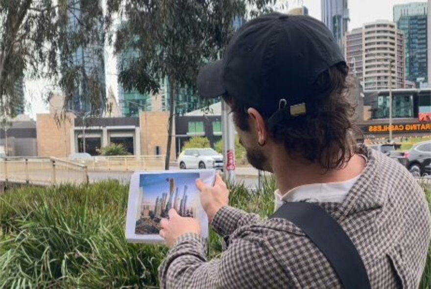 Tour leader showing buildings on an iPad.